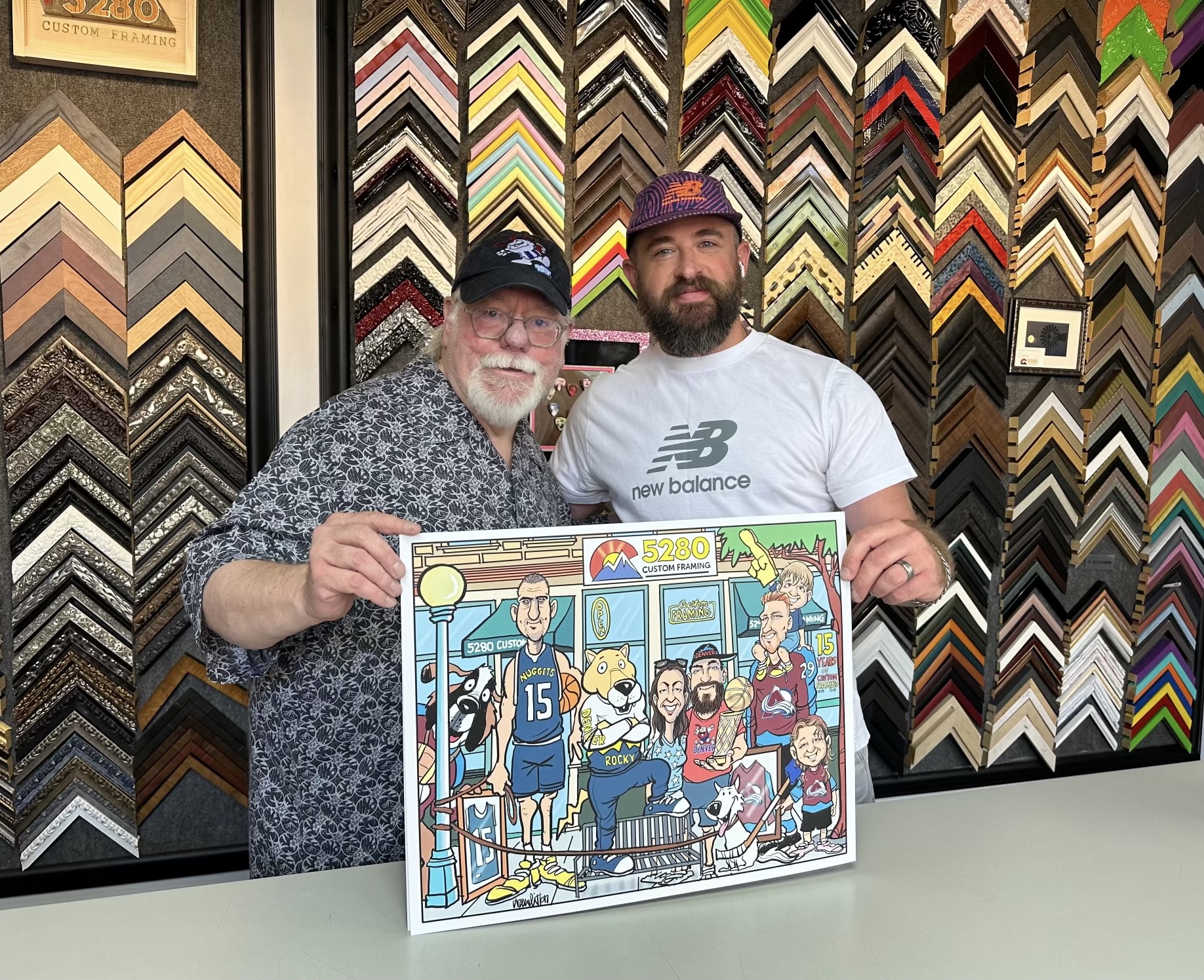 Drew Litton presenting 5280 Custom Framing with a 15th anniversary caricature