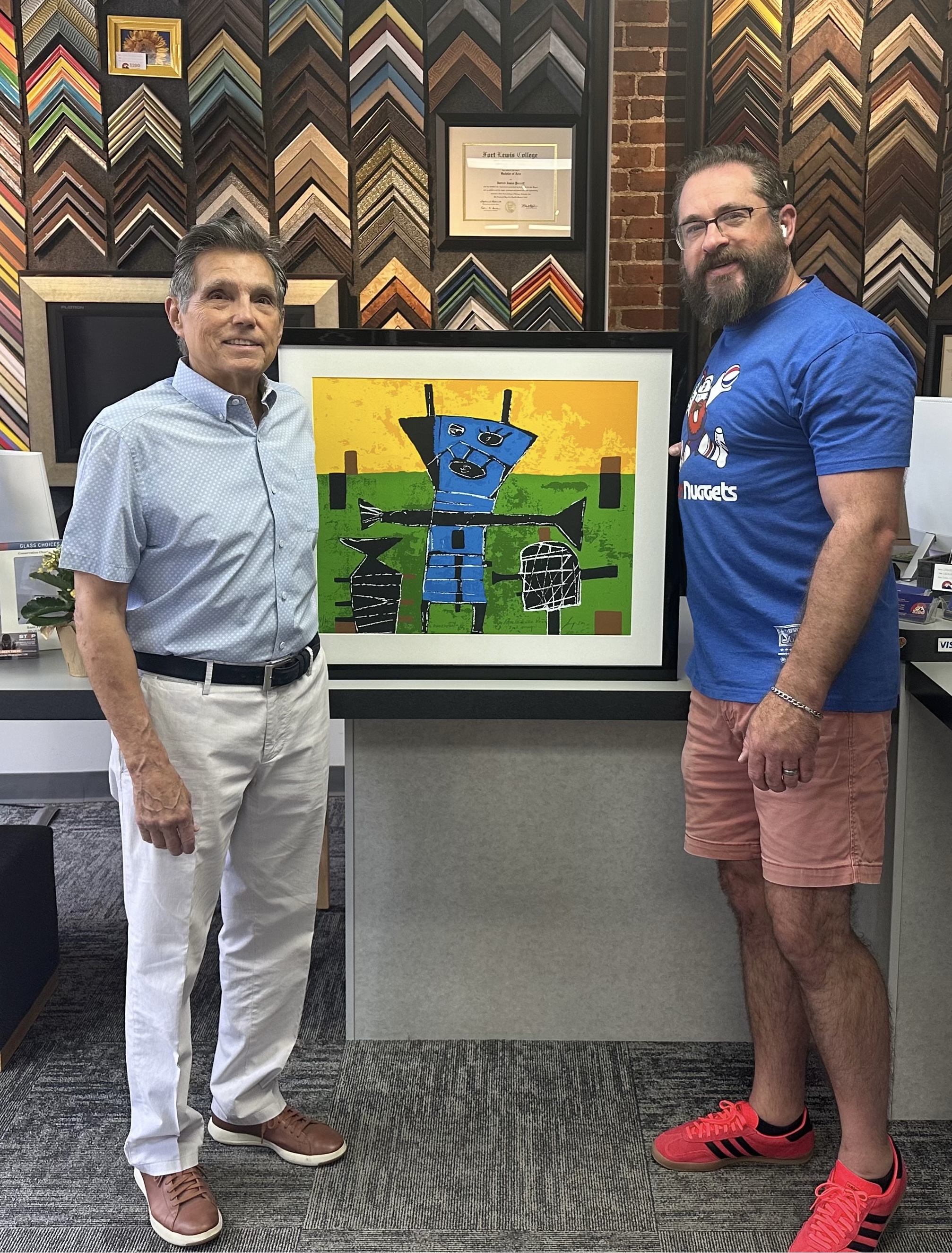 Federico Pena displaying professionally custom framed artwork at 5280 Custom Framing
