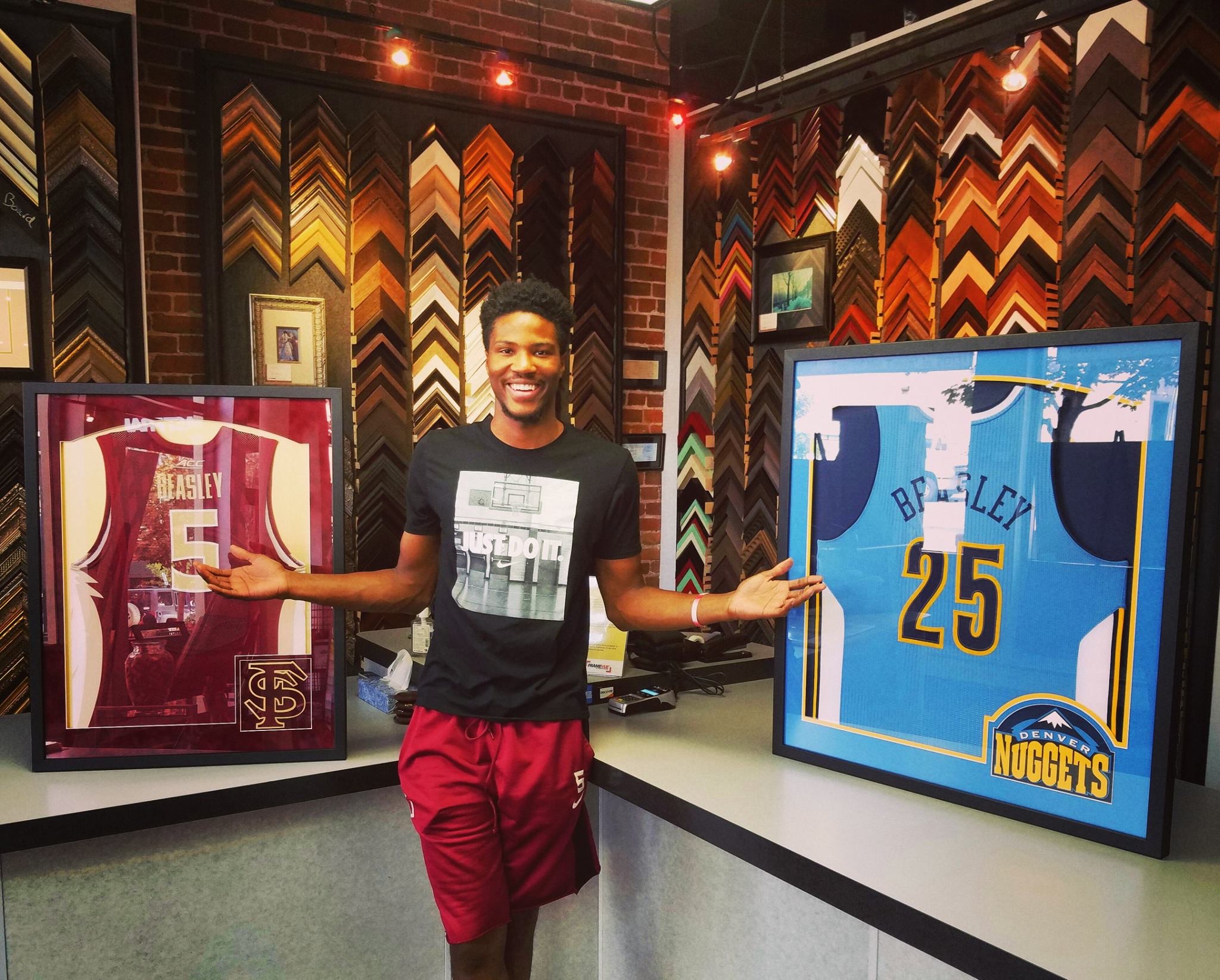 Former Florida State and Denver Nuggets player Malik Beasley with his custom framed basketball jerseys