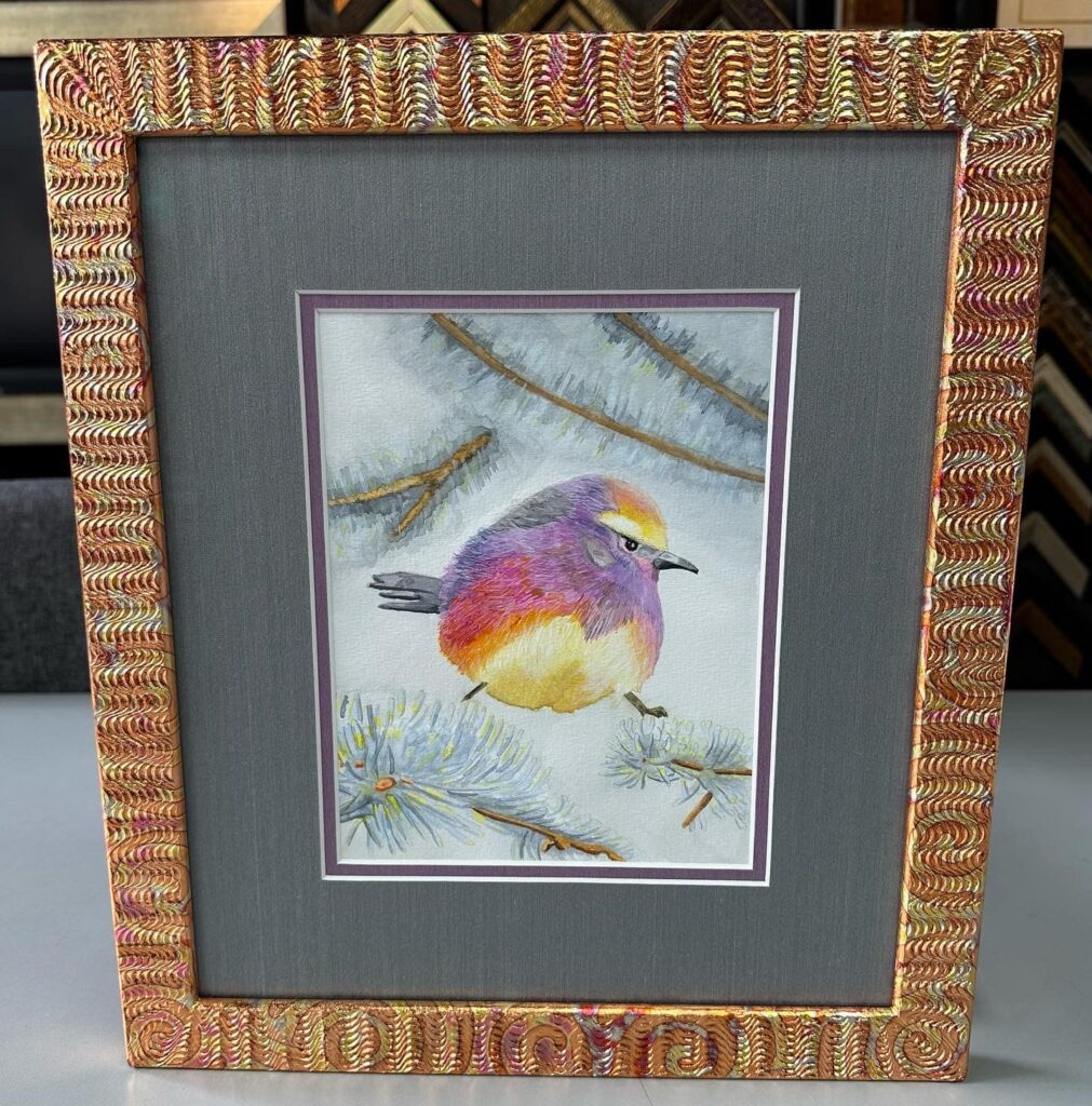 Custom framed watercolor bird artwork with decorative artisan frame