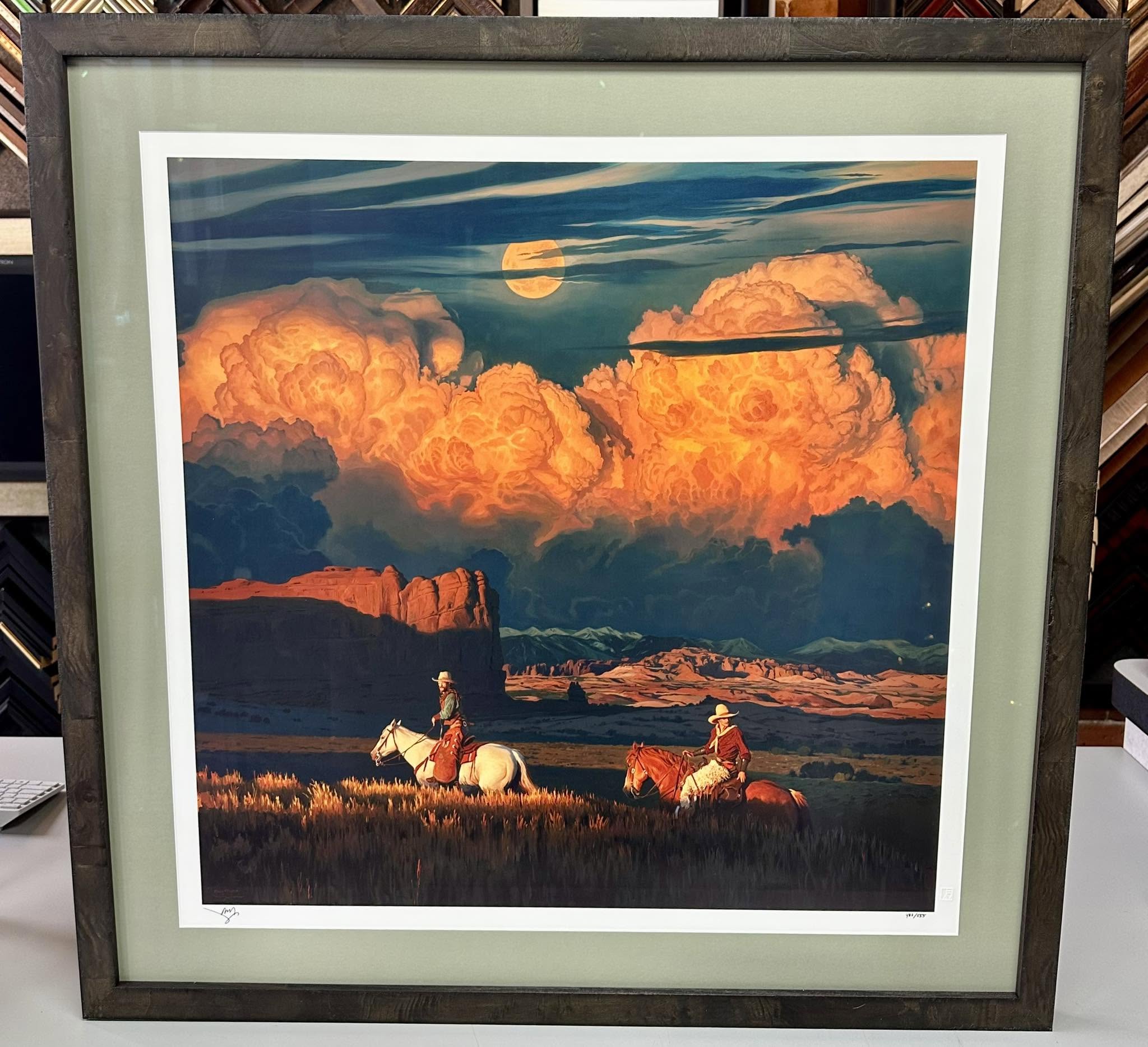 Custom framing for western landscape artwork with rustic wood frame and green mat