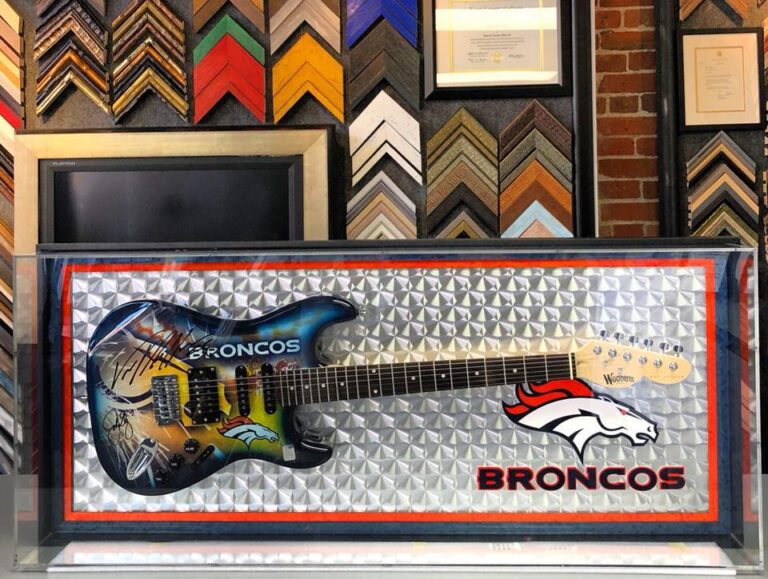 Custom framed Denver Broncos signed guitar and football memorabilia display case