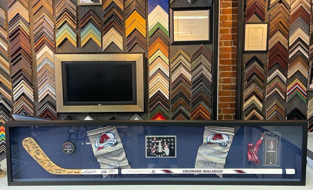Custom framed Colorado Avalanche Stanley Cup championship memorabilia display with signed hockey stick
