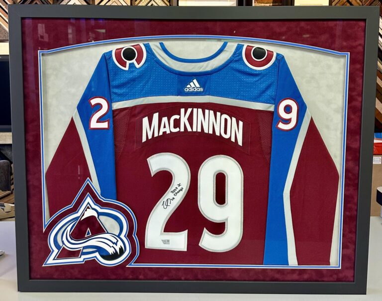 Custom framed Colorado Avalanche Nathan MacKinnon jersey with team logo and sports memorabilia design