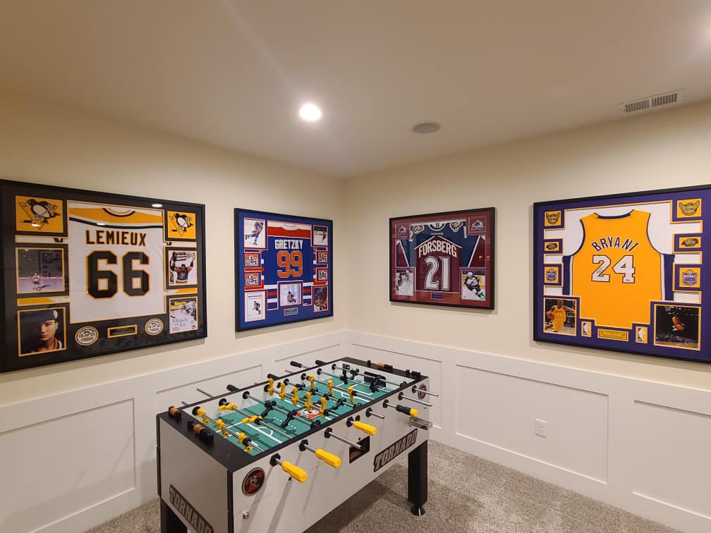Custom framed Mario Lemieux, Wayne Gretzky, Peter Forsberg and Kobe Bryant jerseys displayed in a sports room