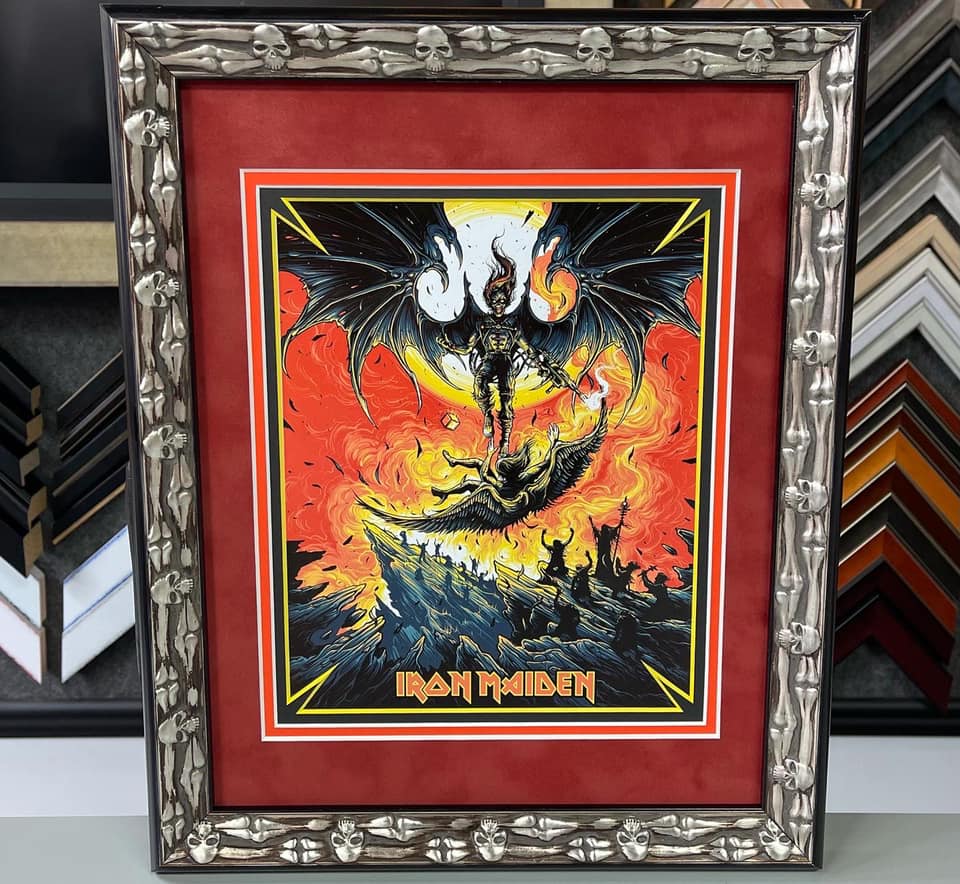 Custom framed Iron Maiden limited-edition print with red matting and an ornate silver skull and bone frame