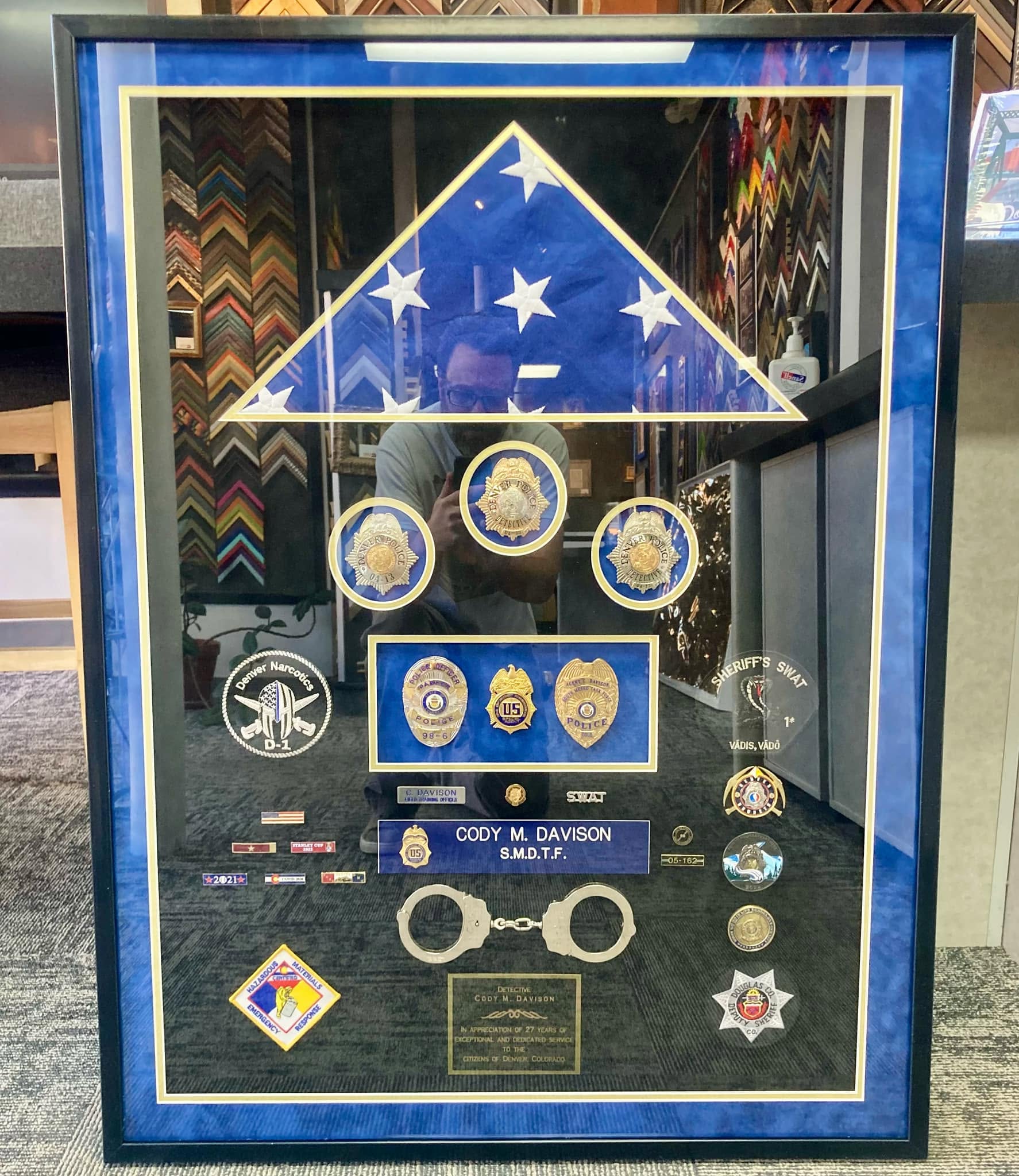 Custom law enforcement retirement shadowbox with folded flag, badges, and memorabilia